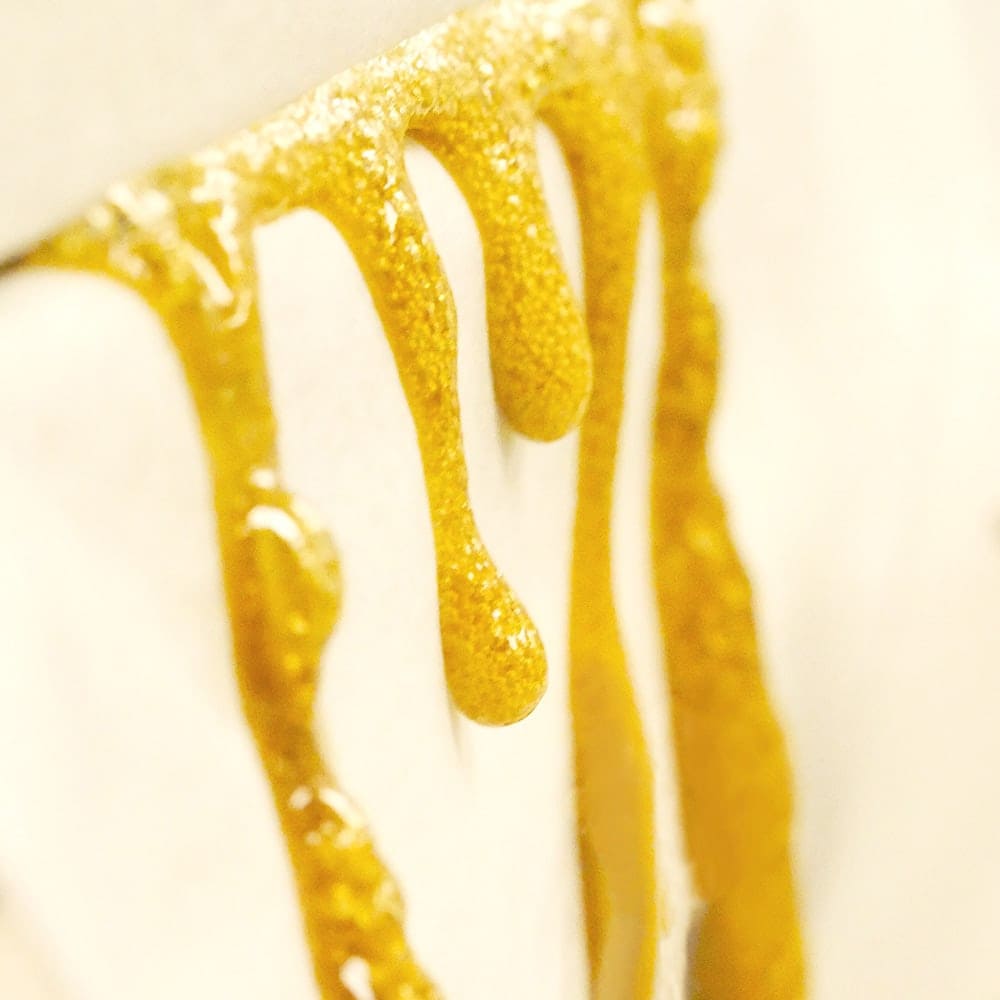 This image shows fresh live rosin oozing from the rosin press. 