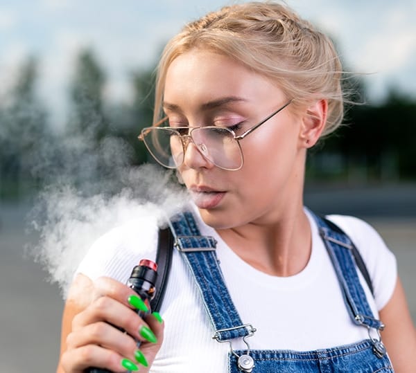 portrait of young woman vaping