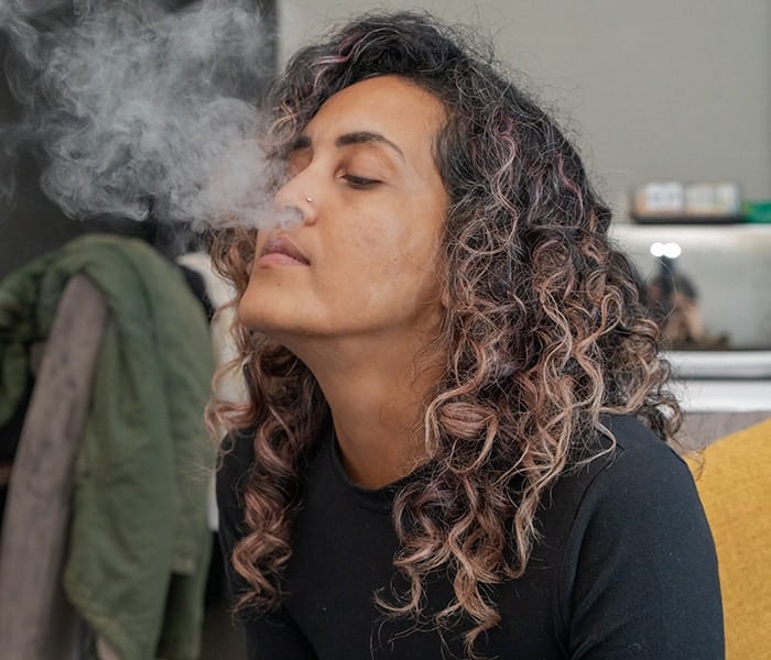 woman seen blowing out smoke