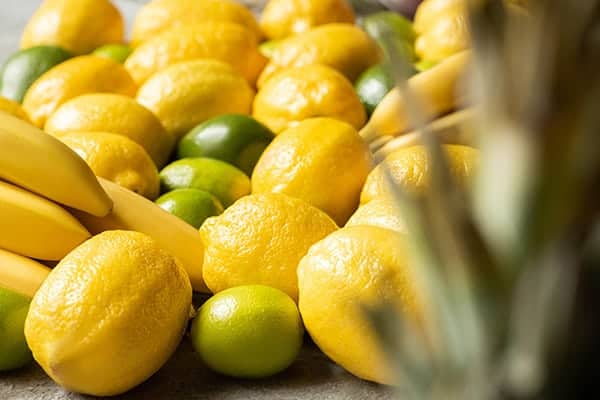 Selective focus on colorful yellow and green lemons and limes.